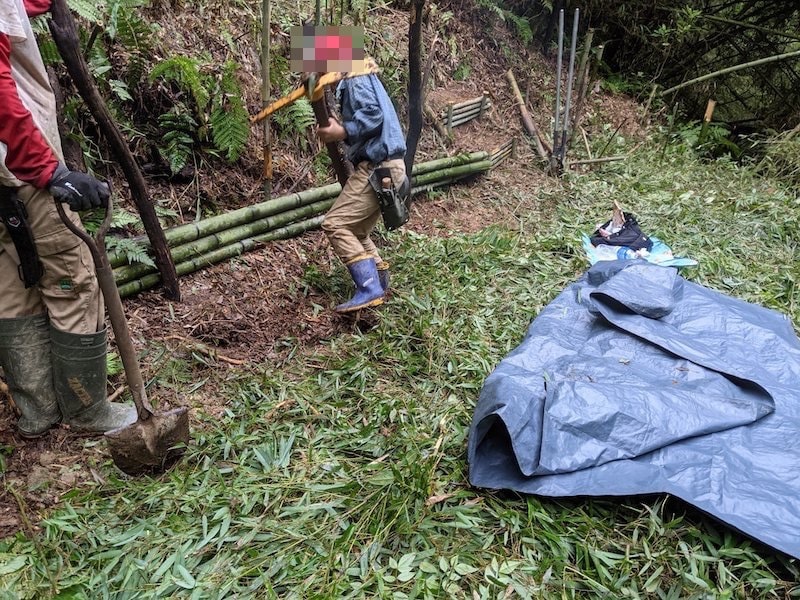 テントのアンダーシートを敷きはじめる。息子がバチヅルで埋もれてる石を除去。